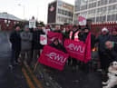 Members of the Communications Workers Union (CWU) and supporters brave freezing temperatures on the picket line outside Royal Mail's office on Hallgate, Wigan