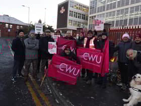Members of the Communications Workers Union (CWU) and supporters brave freezing temperatures on the picket line outside Royal Mail's office on Hallgate, Wigan
