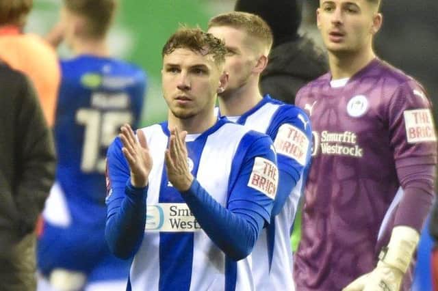 The Latics players thank the supporters for their efforts on Saturday