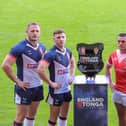 England’s Tom Burgess and George Williams with Tonga’s Tui Lolohea and Keon Koloamatangi with the England v Tonga Test Series Trophy