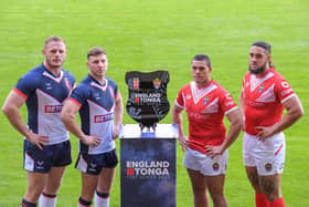 England’s Tom Burgess and George Williams with Tonga’s Tui Lolohea and Keon Koloamatangi with the England v Tonga Test Series Trophy