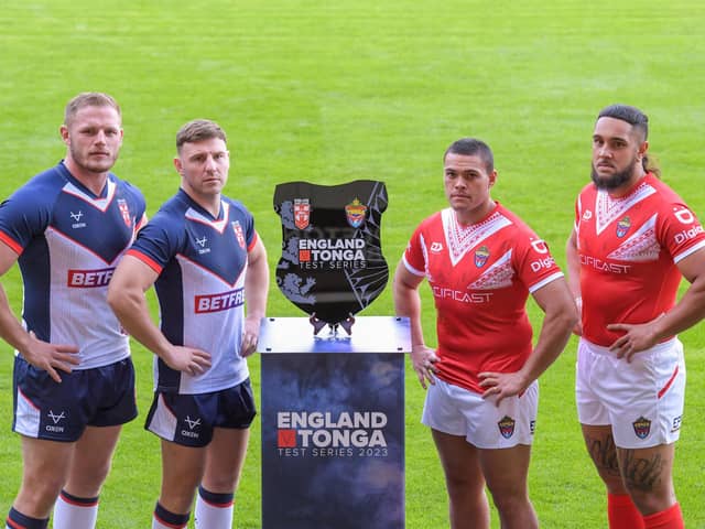 England’s Tom Burgess and George Williams with Tonga’s Tui Lolohea and Keon Koloamatangi with the England v Tonga Test Series Trophy