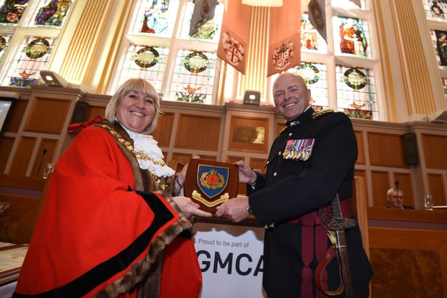 The Mayor of Wigan Coun Marie Morgan, left, is presented with The Duke of Lancaster Regiment crest by Brigadier Frazer Lawrence OBE, right.