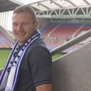 Paul Mullin is all smiles after putting pen to paper at Wigan