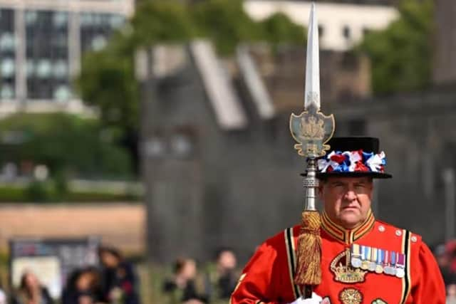 A Yeomen Warders stands guard for the Death Gun Salute fired at the Tower of London by the Honourable Artillery Company, British Army, taking place to mark the death of Queen Elizabeth II.