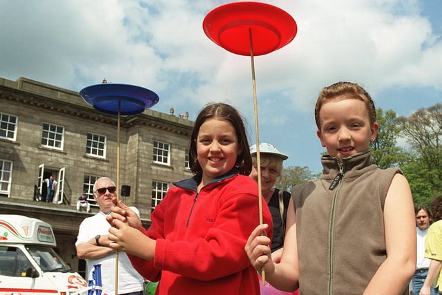 Cousins Vicki Dennis, 11, from Standish, left, and Samantha Acton, 8, from Horwich, try their hand at plate spinning in the main arena