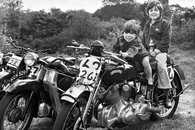 Young lads saddle up on one of the classic motorbikes at a vintage rally on the vicarage field, Warrington Road, Goose Green, in May 1975.