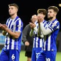 Callum Lang applauds the travelling Latics fans with Charlie Hughes