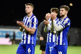 Callum Lang applauds the travelling Latics fans with Charlie Hughes