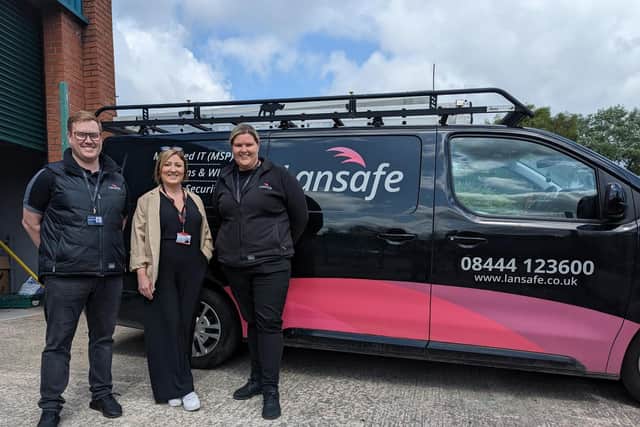 The Brick's CEO Keely Dalfen thanks Ruth Baxendale and Adam Baxendale, from Lansafe, for installing a new security system