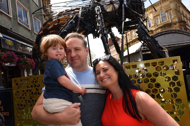 Andy and Gemma Smith with Josh, three, with the Manchester Bee sculpture