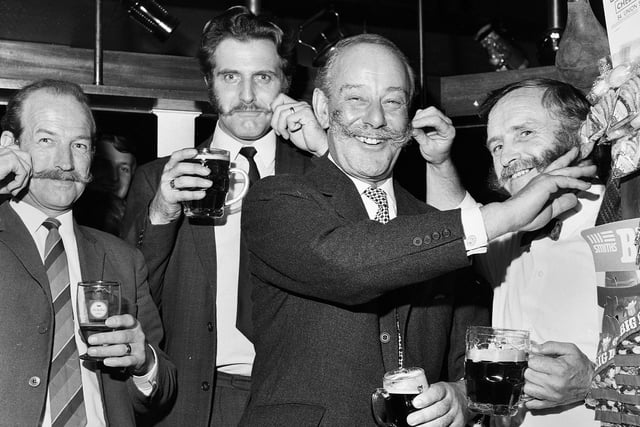 Flamboyant Conservative MP, Sir Gerald Nabarro, famous for his handlebar moustache and controversial views pictured with local bewhiskered gents Fred Hewitt, Malcolm Salmon and landlord, Vincent McGowan, during a visit to the Shepherd's Inn, Lowton, in October 1971. 
Nabarro died in 1973. 