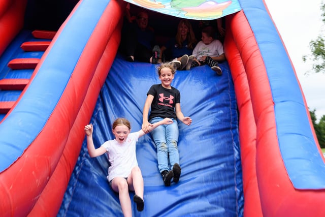 Children at Norley Hall family fun day enjoy a go on the inflatable slide. Photo: Kelvin Stuttard