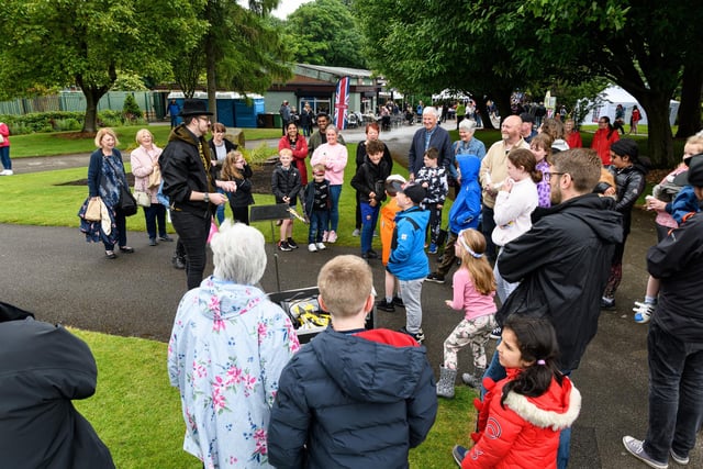 Crowds watch as a magician performs tricks  at the Mayor's Jubilee Gala in Pennington Hall Park, Leigh. Photo: Kelvin Stuttard