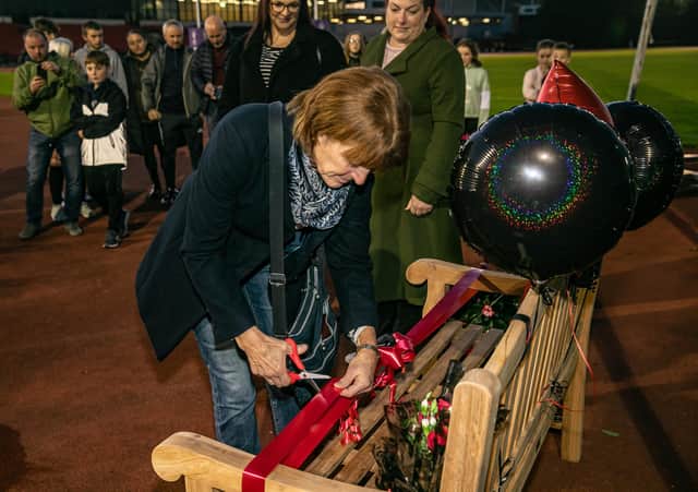 Anne, centre with daughters Vici and Kim cutting the ribbon