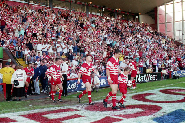 Wigan enter the Central Park pitch for the last time.