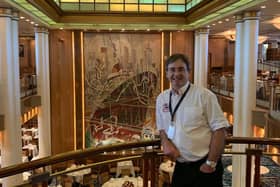 Simon in front of the cleaned tapestry