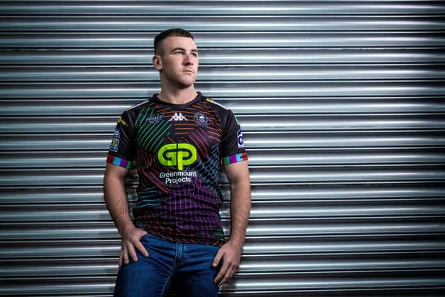 Harry Smith models the club's new charity third shirt