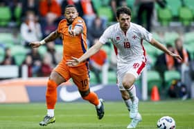 James Carragher shields the ball from Memphis Depay during Malta's World Cup qualifier against Holland in midweek
