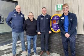 Pine Villa FC's Paul Lingard, Coun Chris Ready, Standish Leisure Centre's general manager Gary Highton and senior leisure assistant Aaron Wragg with the new defibrillator outside the leisure centre