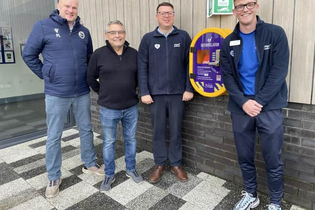 Pine Villa FC's Paul Lingard, Coun Chris Ready, Standish Leisure Centre's general manager Gary Highton and senior leisure assistant Aaron Wragg with the new defibrillator outside the leisure centre