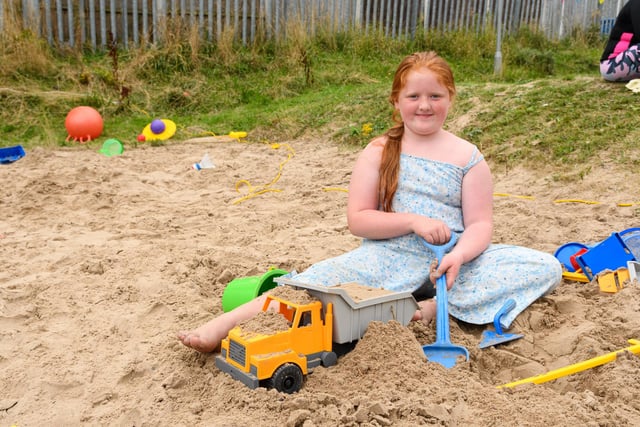 Jasmine Stubbs (10) has fun in the sand at Norley Hall family fun day. Photo: Kelvin Stuttard