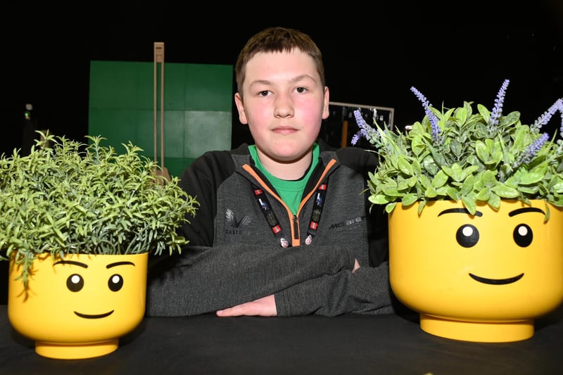 BLACKPOOL - 08-04-23 Lego fans enjoyed workshops, games, stalls and displays at Blackpool Brick Festival, held at the Winter Gardens, Blackpool. Sebbie Freeman, 13, with Lego head planters.