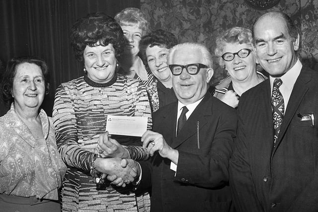 Coronation Street's Albert Tatlock (actor Jack Howarth) receives a charity cheque for £265 from licensees of the Brookhouse Inn on City Road, Kitt Green, Sally and Joe Cook and customers on Wednesday 29th of January 1975.  The money was in aid of the National Spastics Society for which Jack was a collector on behalf of the Stars' Organisation.