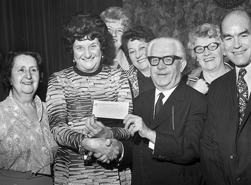 Coronation Street's Albert Tatlock (actor Jack Howarth) receives a charity cheque for £265 from licensees of the Brookhouse Inn on City Road, Kitt Green, Sally and Joe Cook and customers on Wednesday 29th of January 1975. The money was in aid of the National Spastics Society for which Jack was a collector on behalf of the Stars' Organisation.