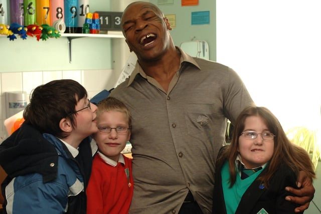 Mike Tyson - the feared boxer was a perhaps surprisingly charming celebrity guest at Hope Special school on a visit arranged by a well connected member of staff. Here he is pictured with pupils, from left, Daniel Walsh, Jack Jones and Pippa Yates.
