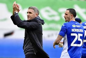 Ryan Lowe applauds the Latics fans following his first home game in charge