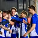 Dale Taylor celebrates his penalty at Exeter with the Latics fans behind the goal