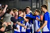 Dale Taylor celebrates his penalty at Exeter with the Latics fans behind the goal