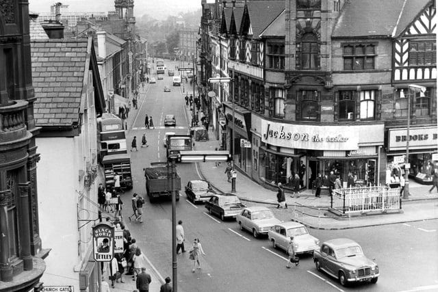 Retro 1960s
A great shot of Wigan town centre in the 1960s looking down Market Street when it was open to two way traffic. The public convenience can be seen opposite  Jackson the Taylors with a line of now classic cars namely a Rover P5 a Ford Anglia a Hillman Hunter, a Vauxhall Cresta and a Rover 2000, and on the other side The Black Horse pub with Tetley sign. Further along a delivery van is replenishing stocks of pies and double decker buses take shoppers into town. 
Towards Queens Hall is The Crofter's Arms on the left of the picture 
