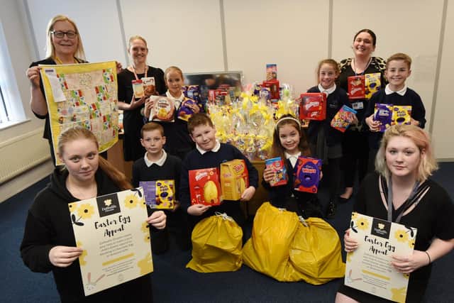Year five pupils and staff from St Mary's Primary School in Ince deliver the Easter eggs to Daffodils Dreams