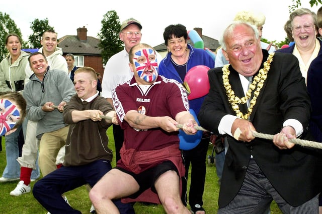 The Mayor of Wigan, Coun. Geoff Roberts, joins in the tug of war at the Worsley Hall Tennants and Residents Association Queens Golden Jubilee party on Tuesday 4th of June 2002.