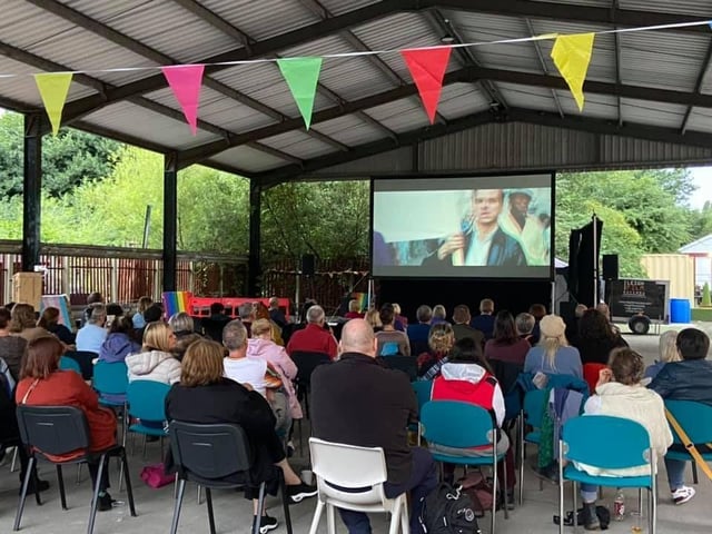 An outdoor screening at the first ever Pride event in Leigh, held in the Leigh Spinners Mill Community bale store.