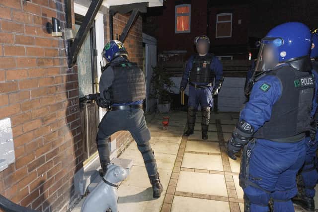 Police bust down door during early morning raids