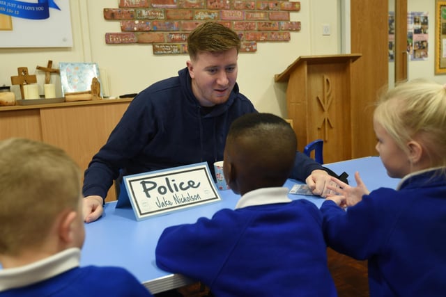 Pupils at St Catharine's chat to a police officer.