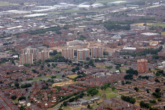 WIGAN AERIAL PICTURES - Wigan town centre and surrounding areas - St Catherine's CE and St Patrick's RC churches, bottom, Scholes flats, the centre, and Robin Park with the JJB Stadium, top.