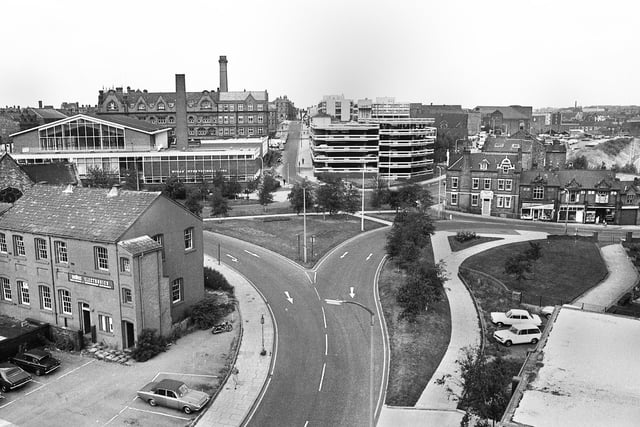 A view looking up Millgate, centre, with Darlington Street and Horse Shoe Hotel on the right and Unilec Electronics and Wigan International Pool on the left in 1976.