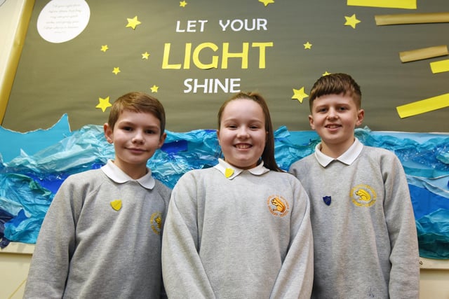 Member of the pupil Leadership team in front of the 'Let your light SHINE' display - a moto for the school.