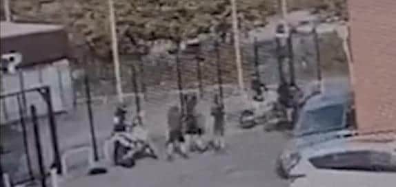 Yobs gang up on the motorcyclist (left)