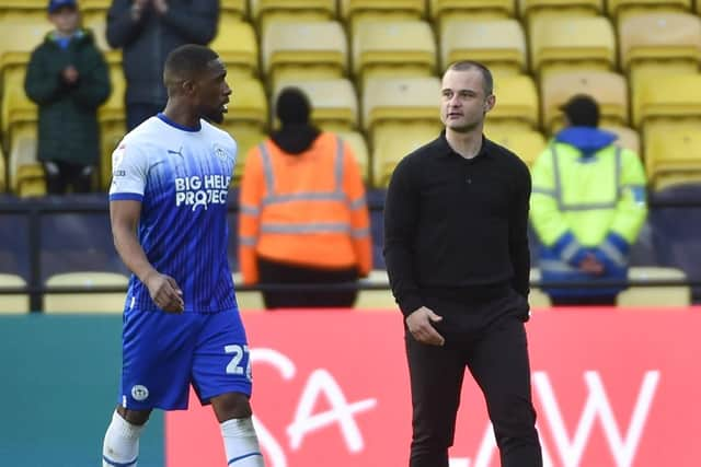 Latics boss Shaun Maloney leaves the field at Watford with skipper Tendayi Darikwa