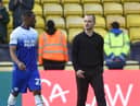 Latics boss Shaun Maloney leaves the field at Watford with skipper Tendayi Darikwa