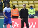 Latics boss Shaun Maloney leaves the field at Watford with skipper Tendayi Darikwa