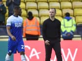 Latics boss Shaun Maloney leaves the field at Watford with skipper Tendayi Darikwa