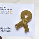 Cancer Research UK's gold ribbon badge