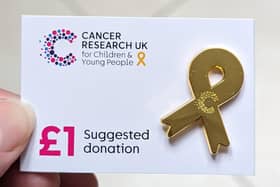 Cancer Research UK's gold ribbon badge