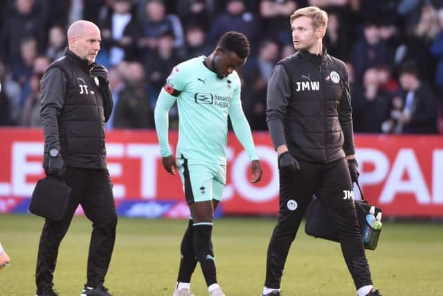 Steven Sessegnon limps off the field at Cheltenham